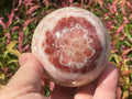 452g (6.3cm diameter) Red Banded Calcite Sphere C