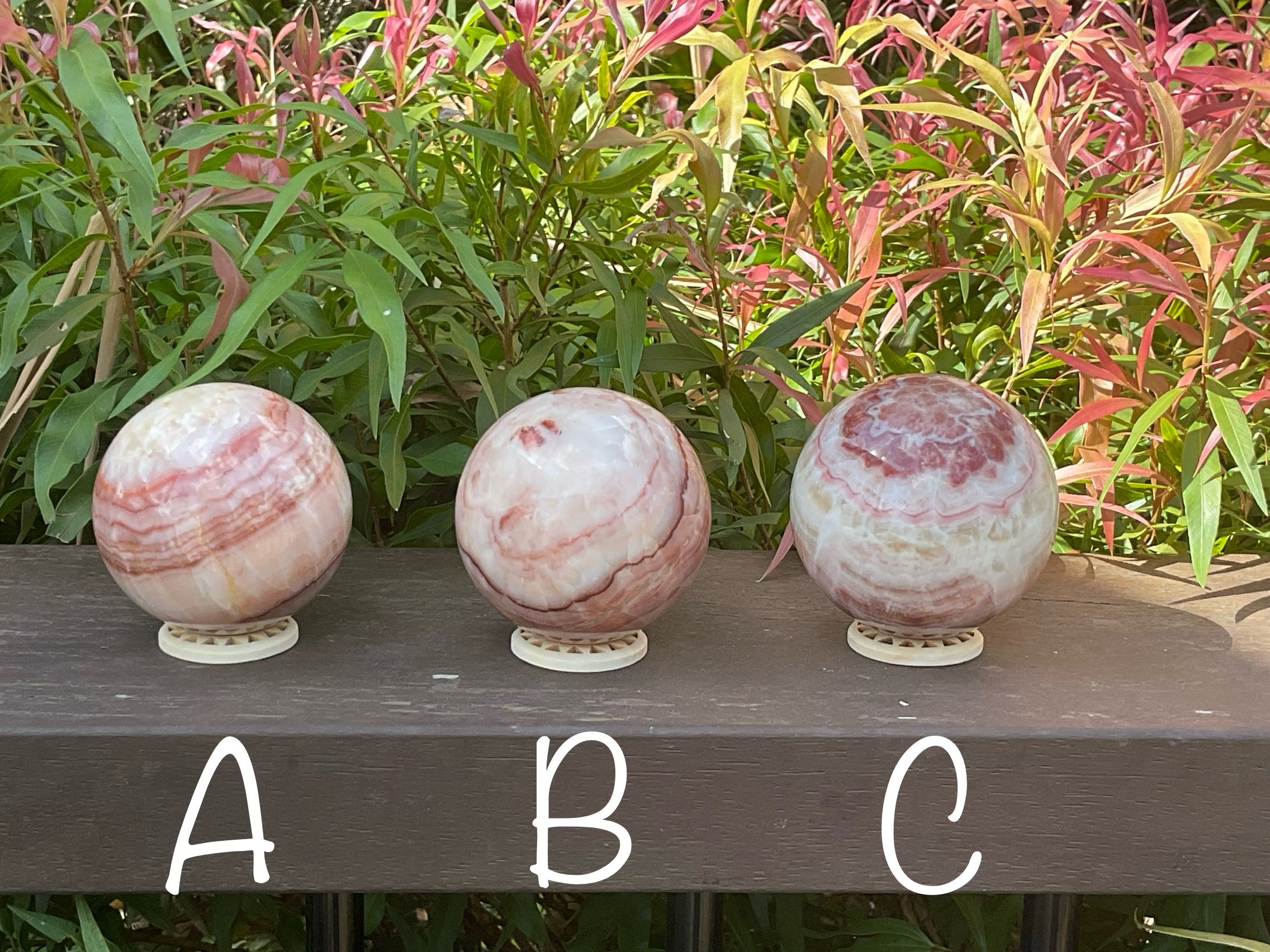 369g (5.9cm diameter) Red Banded Calcite Sphere A