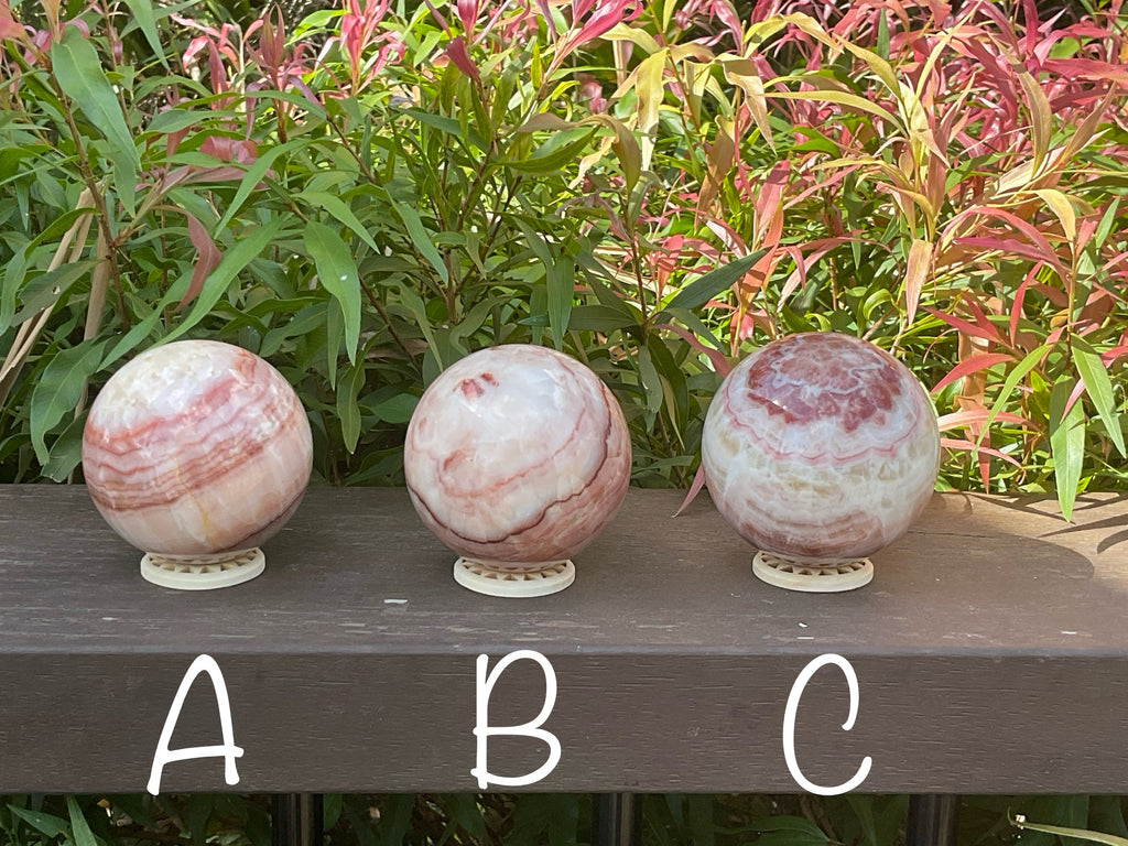 452g (6.3cm diameter) Red Banded Calcite Sphere C