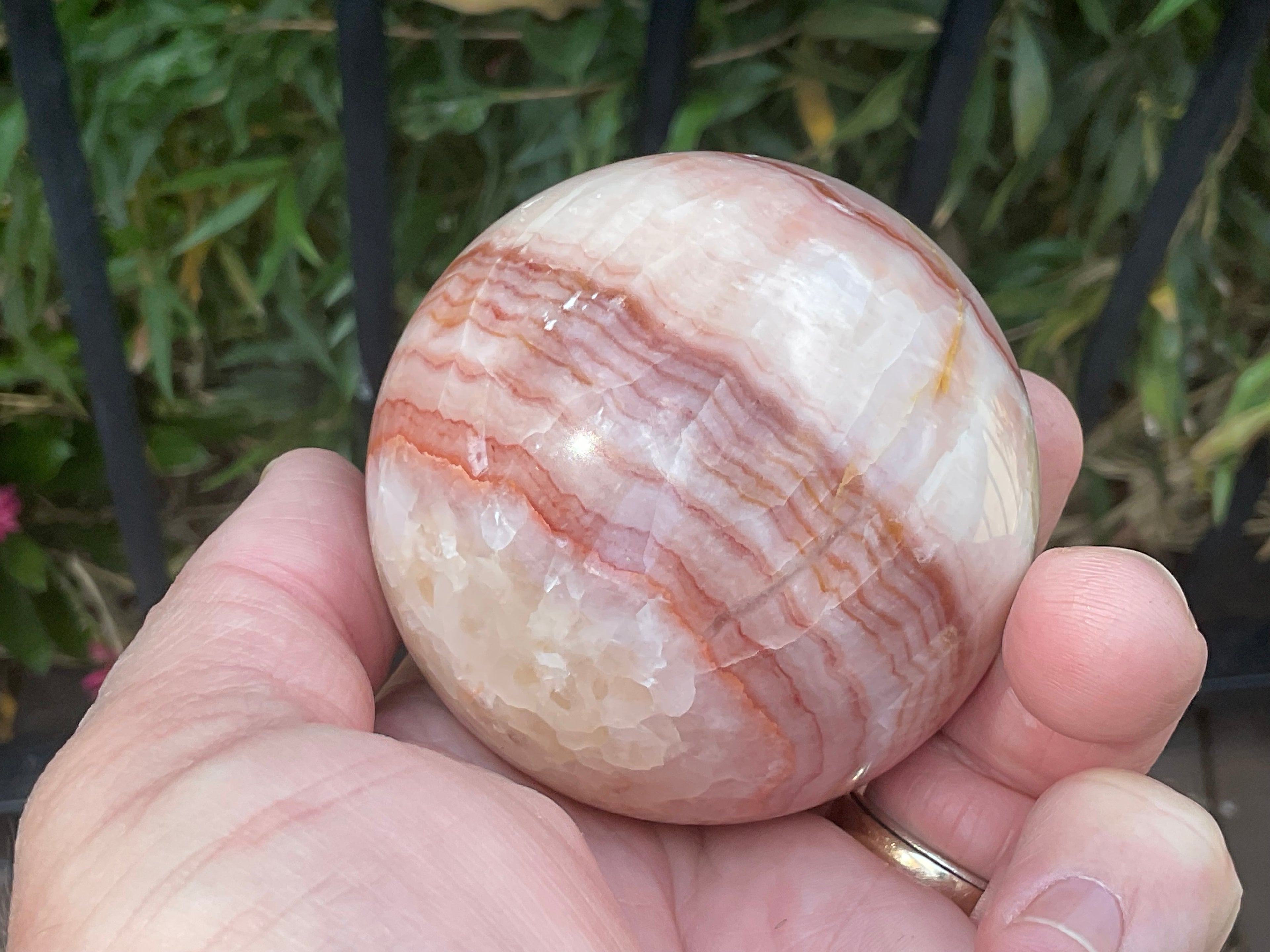 369g (5.9cm diameter) Red Banded Calcite Sphere A