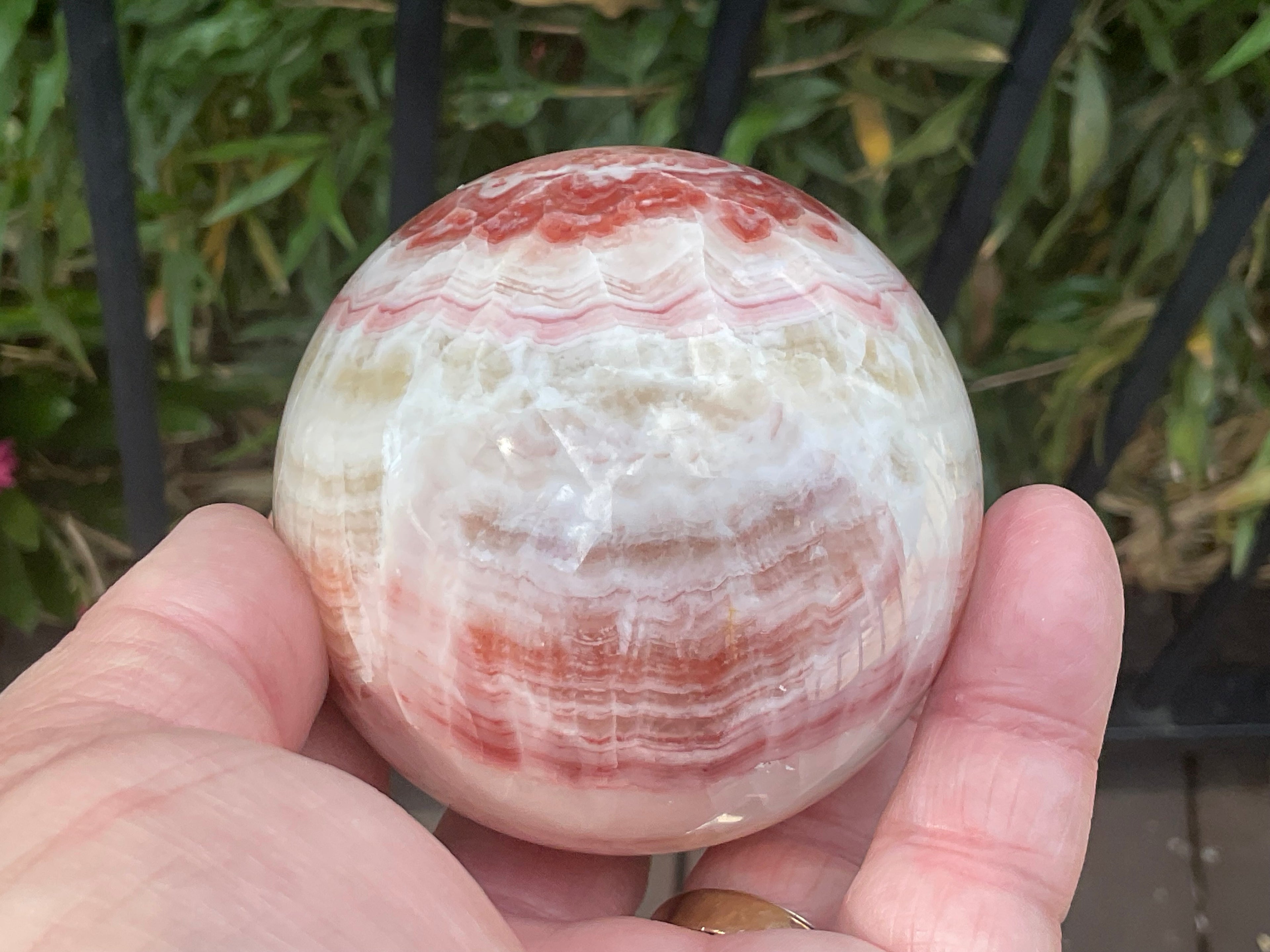 452g (6.3cm diameter) Red Banded Calcite Sphere C