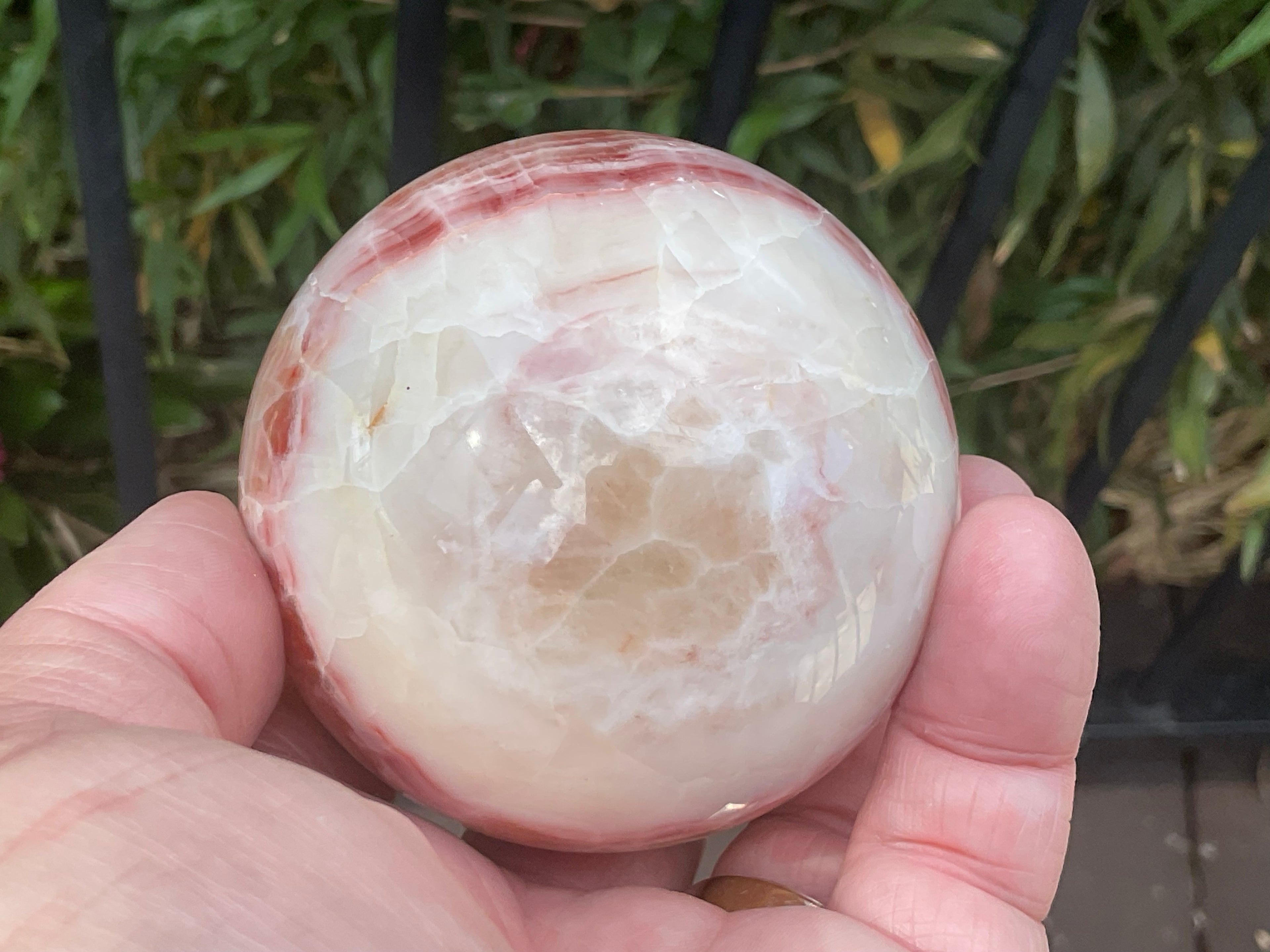 452g (6.3cm diameter) Red Banded Calcite Sphere C