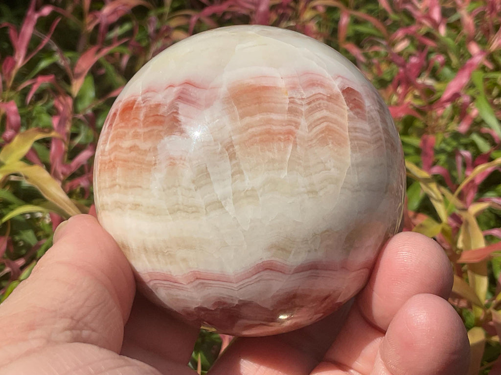 452g (6.3cm diameter) Red Banded Calcite Sphere C