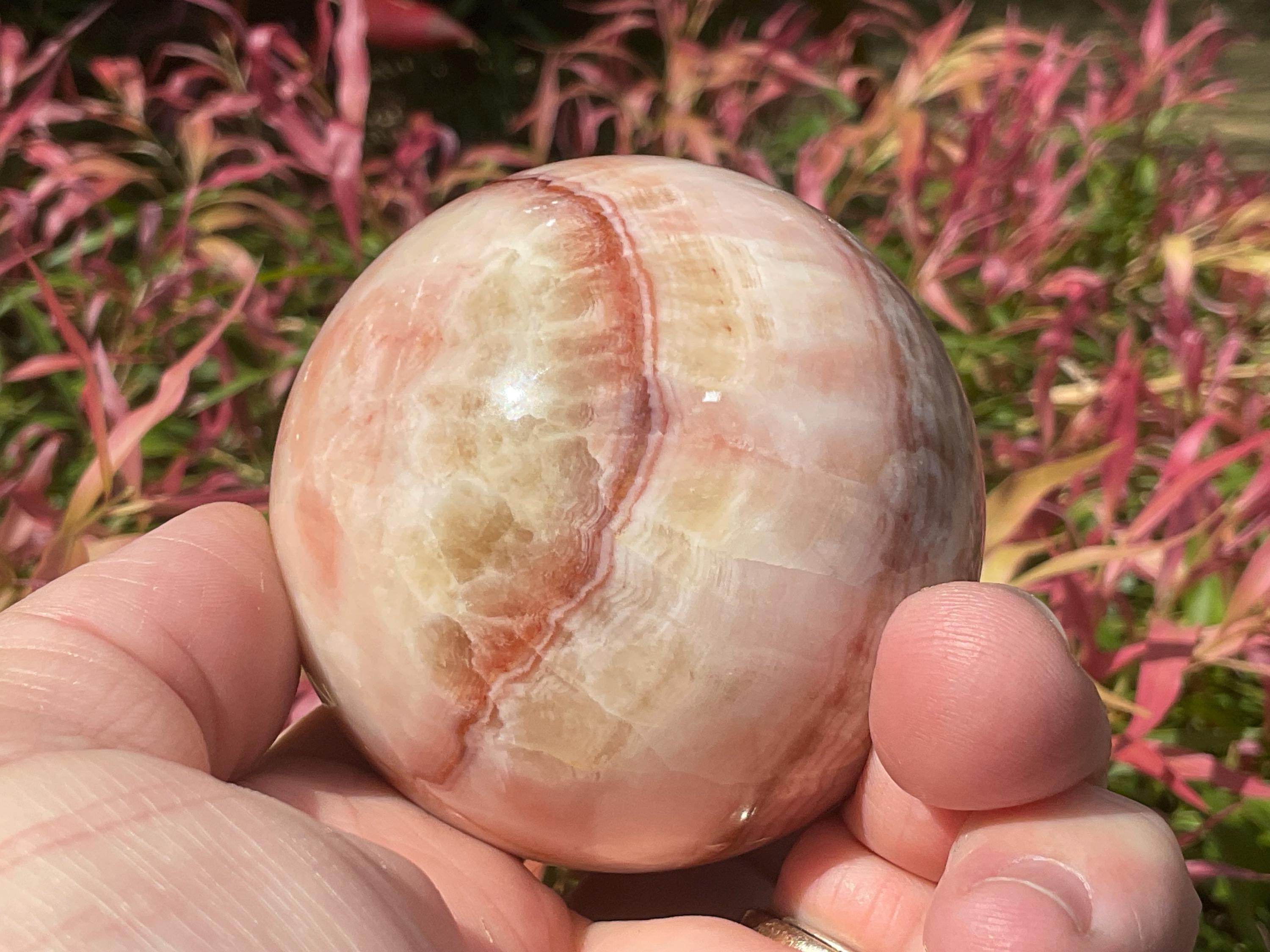 369g (5.9cm diameter) Red Banded Calcite Sphere A
