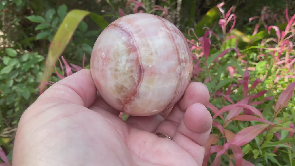 369g (5.9cm diameter) Red Banded Calcite Sphere A